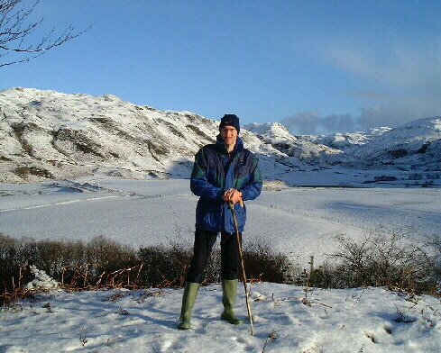 Iain Jr with the snow covered Glen in the background